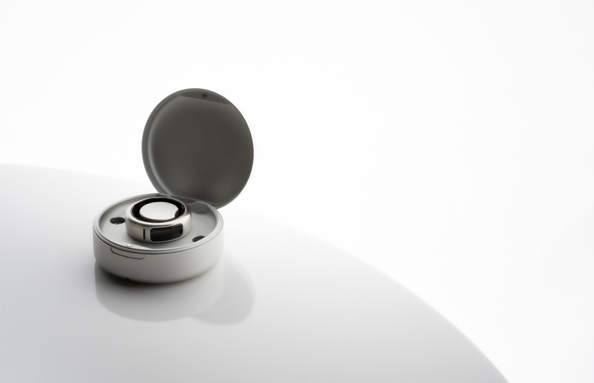 OASIS smart ring in its charging case